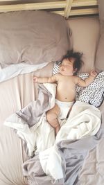 High angle view of baby sleeping in bed