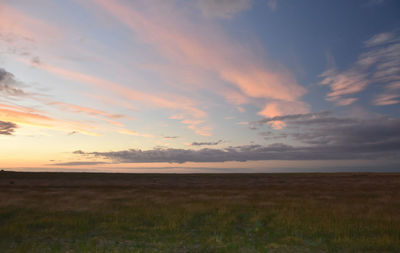 Scenic view of field against sky during sunset