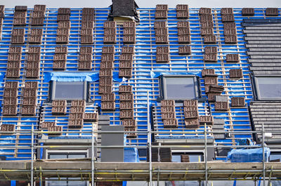 Low angle view of construction site against blue sky