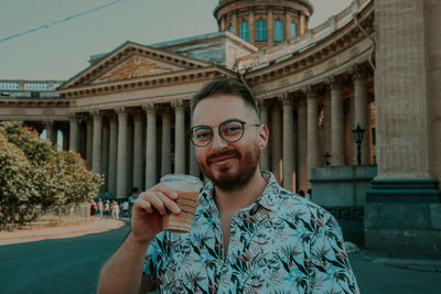 Portrait of young man in city