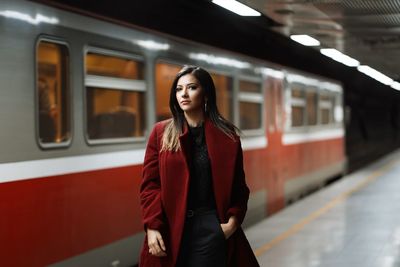 Portrait of beautiful woman standing at railway station