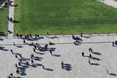 High angle view of people walking on footpath in city