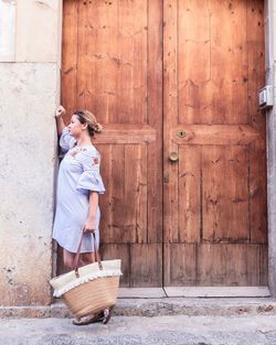 Full length of woman standing in front of door