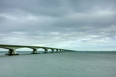 Bridge over sea against sky