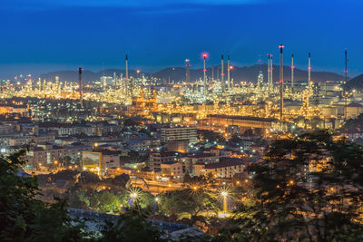 Illuminated cityscape against sky at night