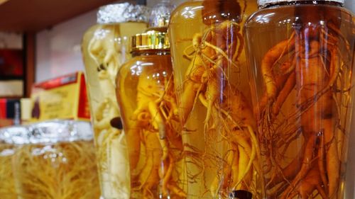 Close-up of ginseng in glass jars