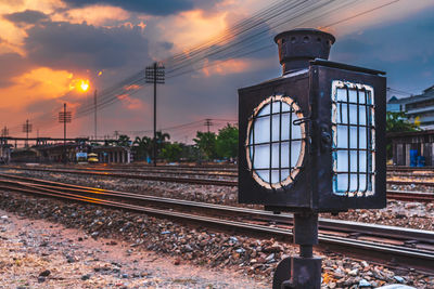 Railroad tracks against sky at sunset