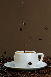 Close-up of coffee cup against black background