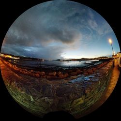 Panoramic view of beach against sky at sunset