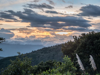 Scenic view of mountains against sky at sunset