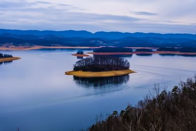 Scenic view of lake against sky during sunset