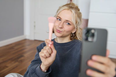 Portrait of young woman using mobile phone