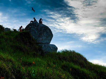 Low angle view of silhouette statue against sky