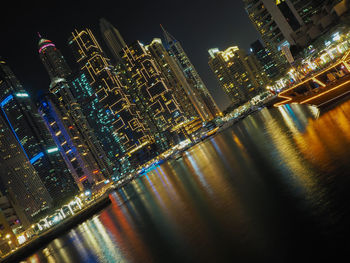 Aerial view of illuminated buildings in city at night