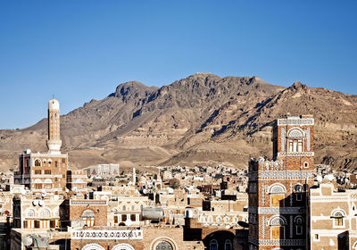 Aerial view of buildings against blue sky