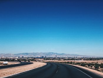 Highway against clear blue sky