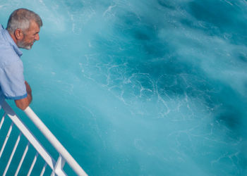 High angle view of man standing in swimming pool