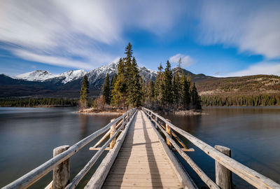 Scenic view of pier over lake against sky