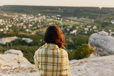 Rear view of woman standing outdoors