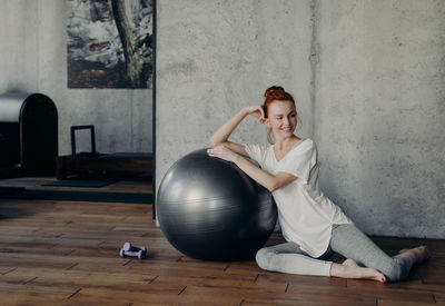 Woman sitting with exercise ball