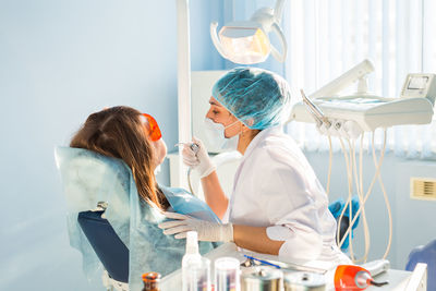 Dentist examining teeth of patient