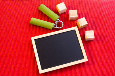 High angle view of exercise equipment with blackboard and blocks on table