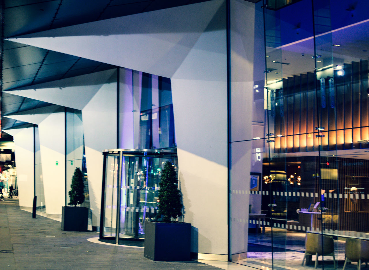 ILLUMINATED MODERN BUILDINGS AT NIGHT