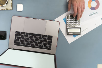 Low section of person using laptop on table