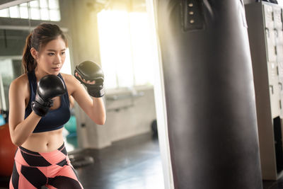 Determined woman boxing at gym