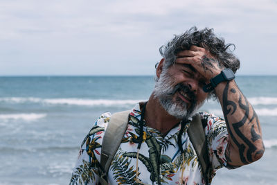 Portrait of a modern middle aged man in casual shirt on the beach