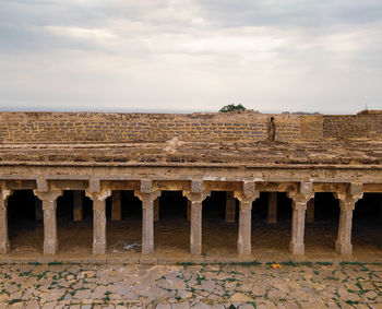 Old ruins of building against cloudy sky