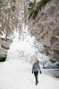 Female hiker enjoys snowy johnston canyon