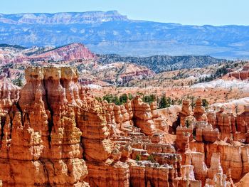 Hoodoo and pine trees in bryce canyon national park in utah blue partly cloudy skies.