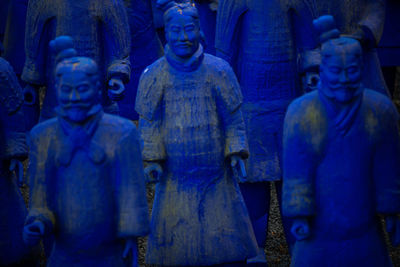 Statue of buddha against blue wall