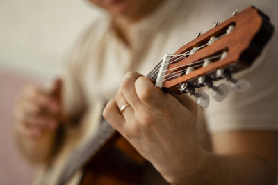 Man playing guitar at home