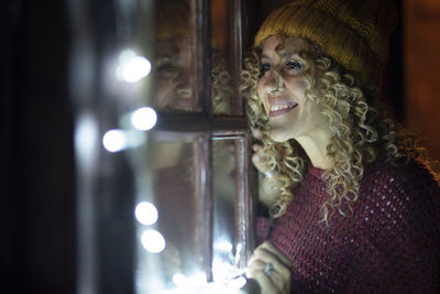 Smiling woman looking through window