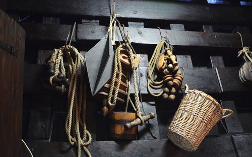 Close-up of fishing equipment hanging on wood