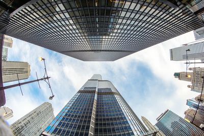 Directly below view of modern office buildings against sky