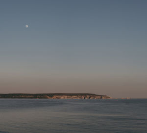 Scenic view of sea against clear sky during sunset