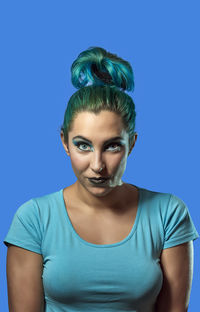 Portrait of a woman against blue background