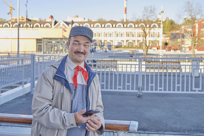 Senior asian man in red tie, former member of childrens pioneer organization in soviet union