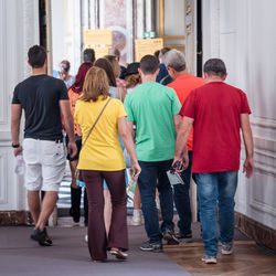 Rear view of people walking in city