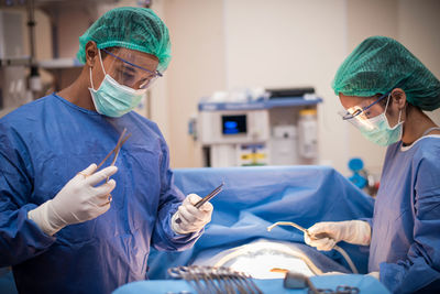 Surgeons operating patient in hospital