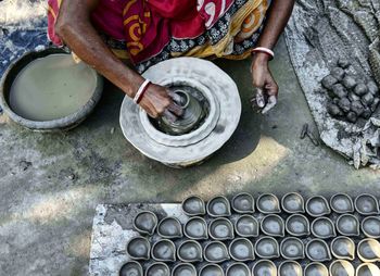 Low section of woman making earthenware