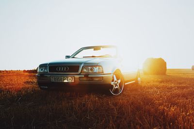 Vintage car on field against clear sky