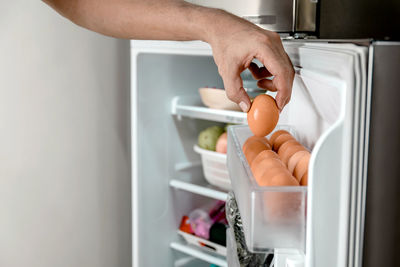 Cropped hand of person preparing food at home