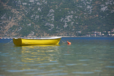 Yellow boat without people in sea water