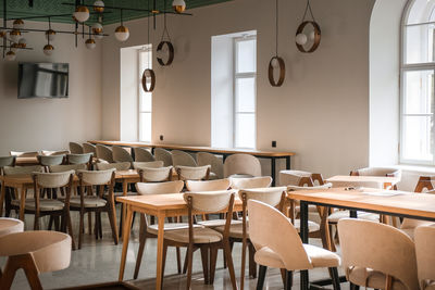 Empty chairs and tables in restaurant