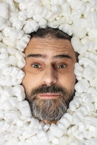 Close-up portrait of man covered with polystyrene