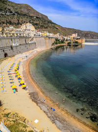 High angle view of beach by buildings against sky